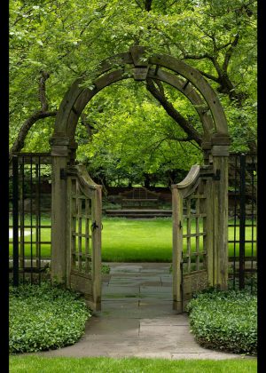 Wooden arched gate with paved walkway