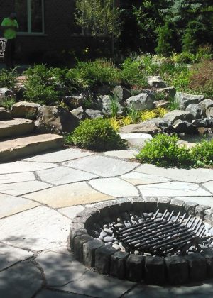 Brick and bluestone stone patio with stone steps, irregular bluestone curb fire pit with gun metal water feature