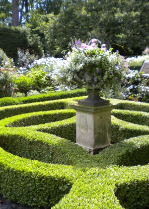 Boxwood Parterre in Perennial Garden with lead urn atop a limestone pedestal
