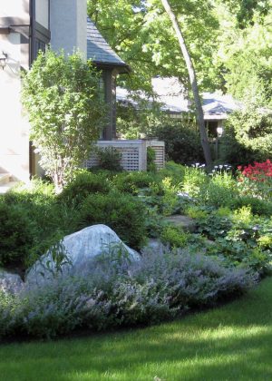 Perennial border planting with granite boulder outcroppings