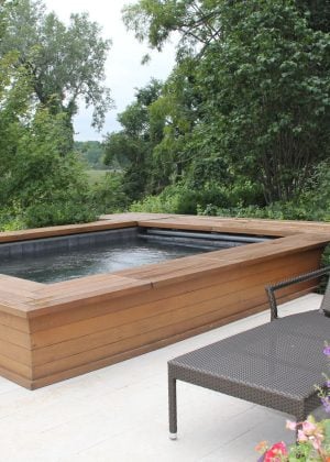 Contemporary rectangle hot tub spa. Cedar planks on hot tub reflect plank pavers