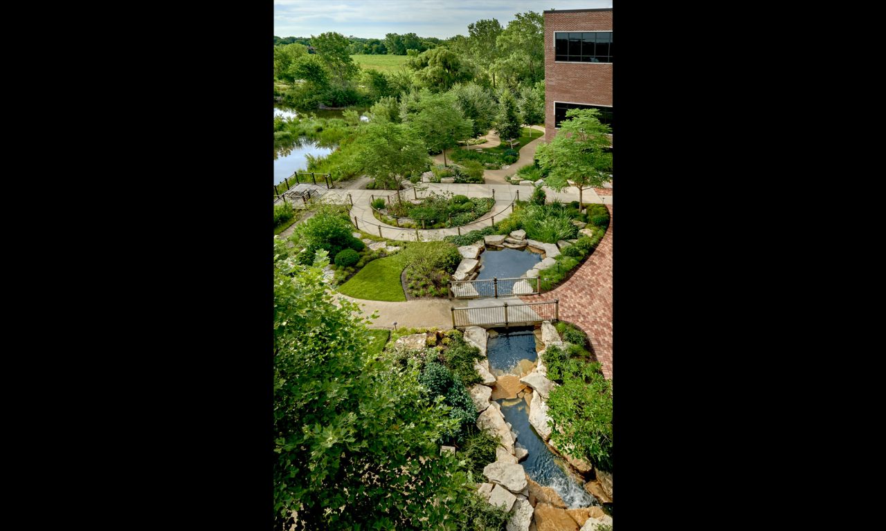 Aerial view of a healing garden including: fountani, multiple pathways, pond, and boulders