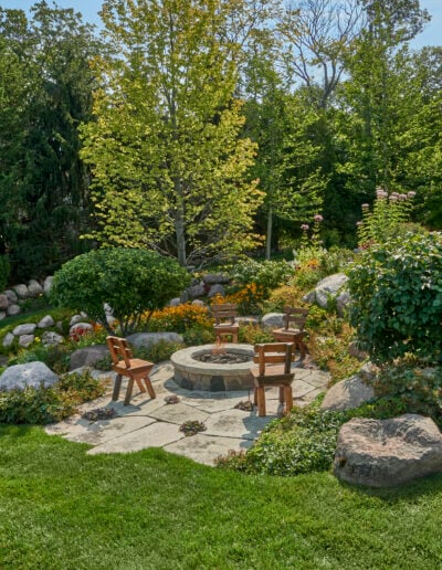Fire pit set among rolling flower beds