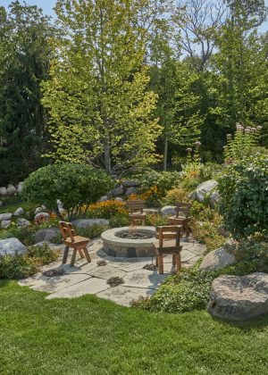 Fire pit set among rolling flower beds