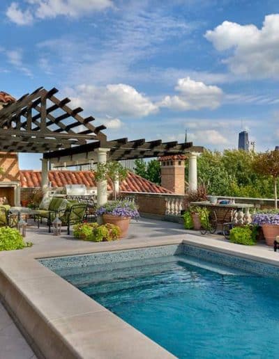 Outdoor pool hardscape design with pool overlooking the Chicago skyline